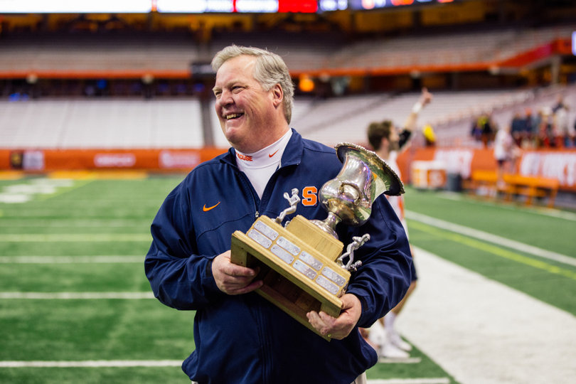Syracuse director of lacrosse operations Roy Simmons III holds the Kraus-Simmons trophy named after his grandfather. 