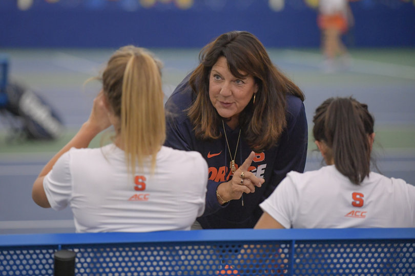 Associate head coach Shelley George coaches Ramriez and Knutson during their doubles win.