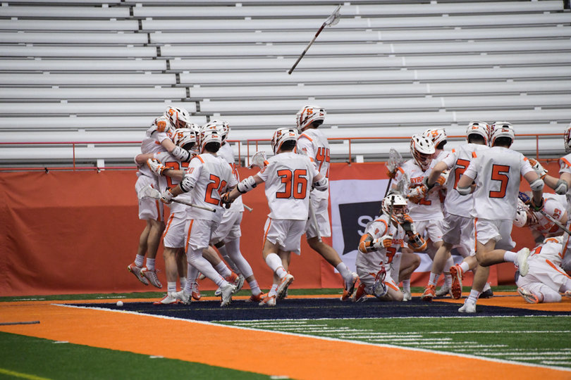 Syracuse swarms Brendan Bomberry, who scored the game-winning goal in overtime. 