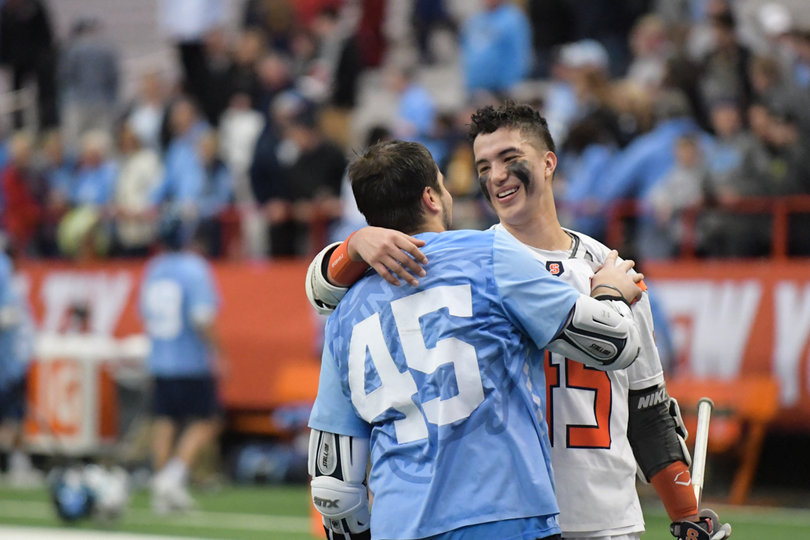 Brendan Bomberry and Chris Cloutier embrace post game. The two went to The Hill Academy together and both wear No. 45 in honor of Jamieson Kuhlmann, a former Hill player. 