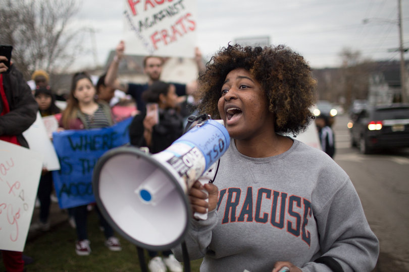 Sophomore Tayla Myree shouts into a megaphone at a protest outside Chancellor Kent Syverud's house Wednesday evening.