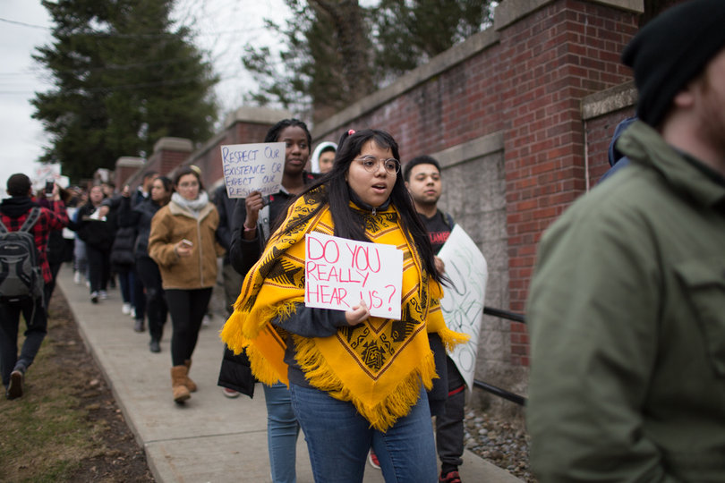 Students march down Harrison Avenue, chanting, "Hey hey! Ho ho! Theta Tau has got to go!"