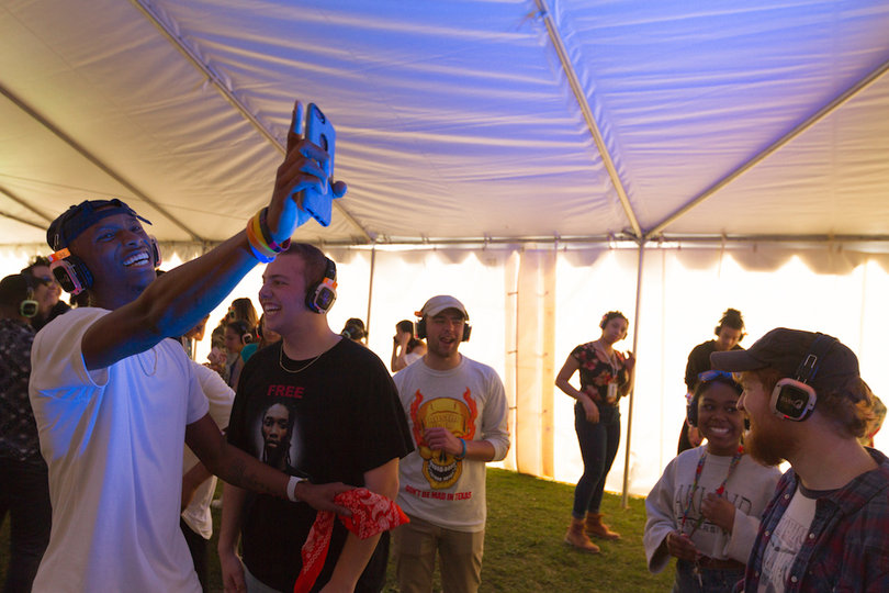 The silent disco tent was in its own tent to enhance the experience of listening to music through personal headphones. 
