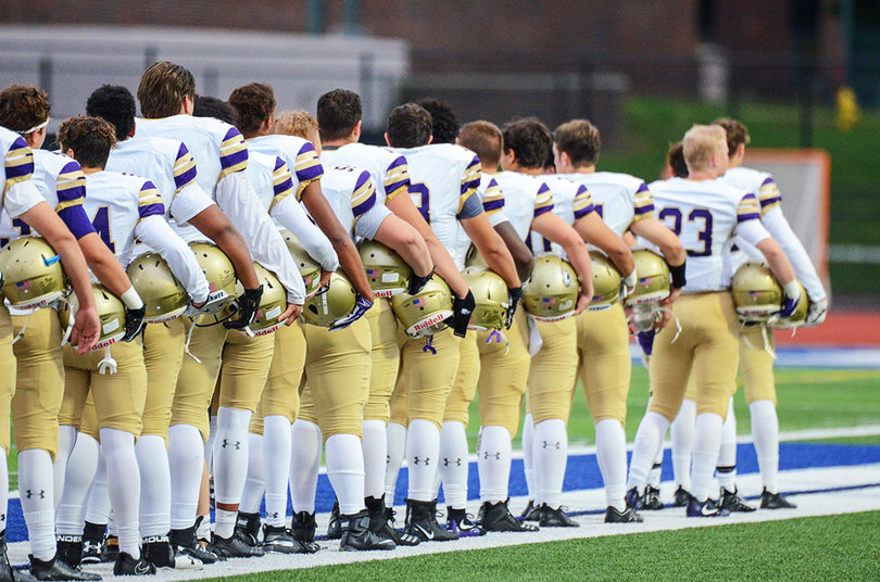 CBA lines up for the national anthem, which was sung by a local fourth grader.