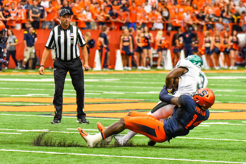Foster makes a tackle.