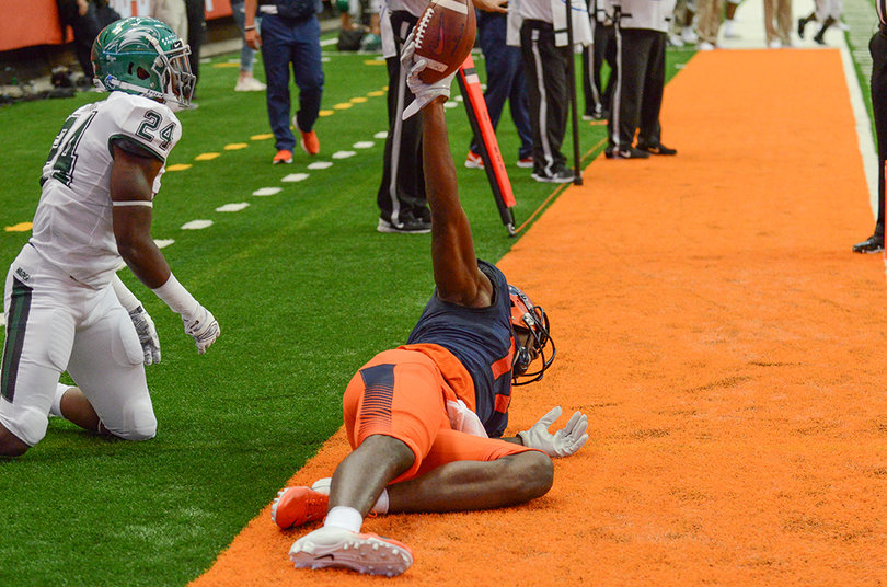 Custis holds the ball up on the sideline.