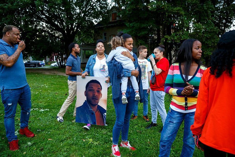 Family members connected to Lawrence Moore Jr., a 2018 homicide victim, await the start of a prayer vigil against the rash of violence in Syracuse on Friday, Sept. 21.