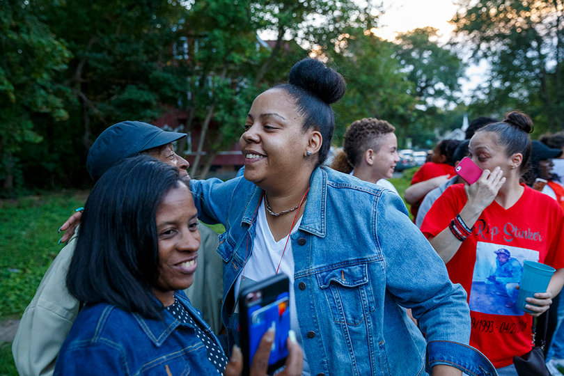 Ashley Delee embraces a man in attendance at the prayer vigil after a preacher encouraged the crowd to hug the person next to them. 