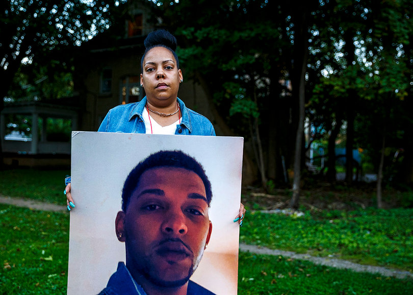 Ashley Delee holds a photograph of her nephew, 24-year-old Lawrence Moore Jr., who was fatally shot in April. She identified Moore's daughter as a victim in the mass shooting on Thursday, Sept. 20.