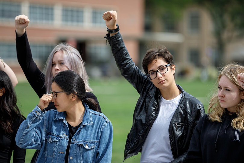 Clark Bermudez raises a fist, showing that they will continue to fight and speak out against sexual violence.