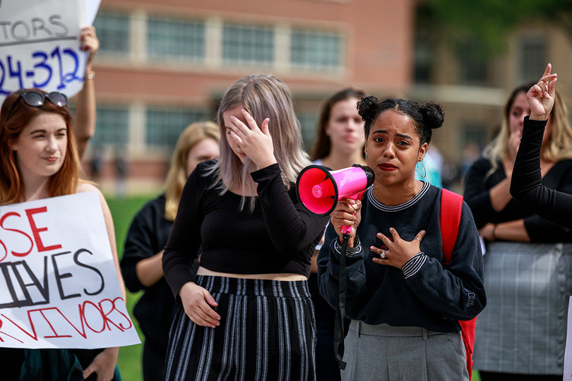 Nicole Aramboles, a freshman in the College of Visual and Performing Arts, participates in a protest against Judge Brett Kavanaugh on the Quad.