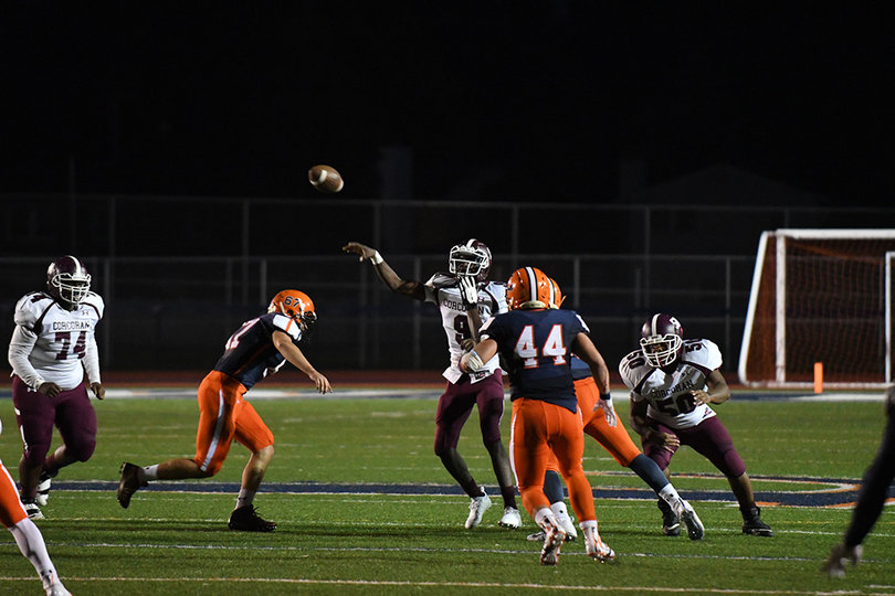 Corcoran's Dewayne Young throws under pressure. He completed four out of his eight passes.