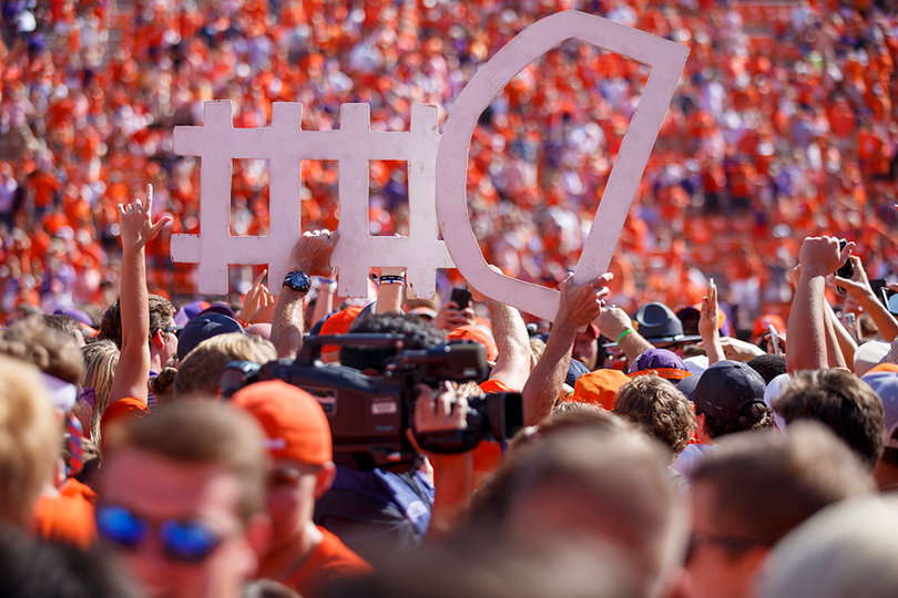 Clemson fans hold up a sign urging the Tigers' defense.