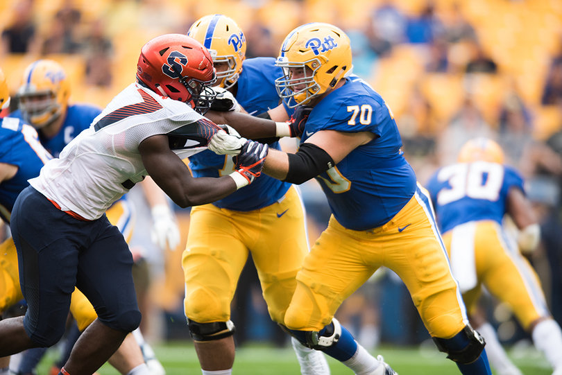Pittsburgh Panthers offensive lineman Stefano Millin (70) holds onto Syracuse Orange defensive back Kingsley Jonathan (57).