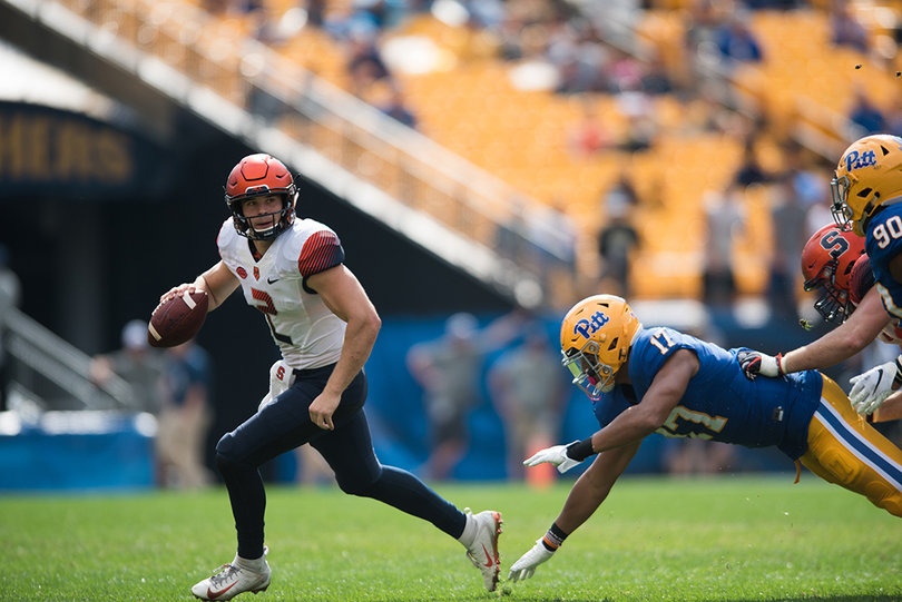 Pittsburgh defensive lineman Rashad Weaver (17) dives for Syracuse quarterback Eric Dungey (2).