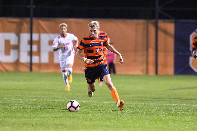 Soerlie dribbles the ball out in front of him.