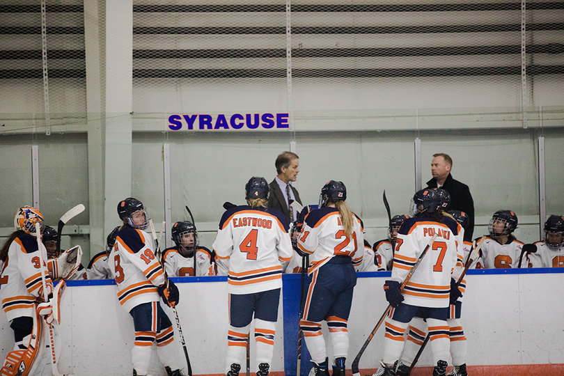 The Orange meet at their bench in between whistles. 