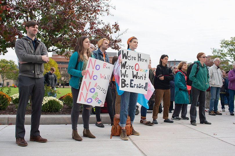 Students hold signs at the rally: (from Mason Miessau-Valcore (sign language interpreter), Rylee (first-year SUNY-ESF), Quincy Nolan (senior communication and rhetorical studies major at SU), Lenny (first year SUNY-ESF) and Rose (first-year SUNY-ESF)