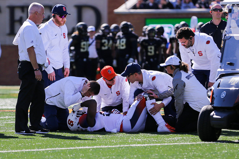 Syracuse senior Tyrone Perkins went down early in the game and had to be carted off.