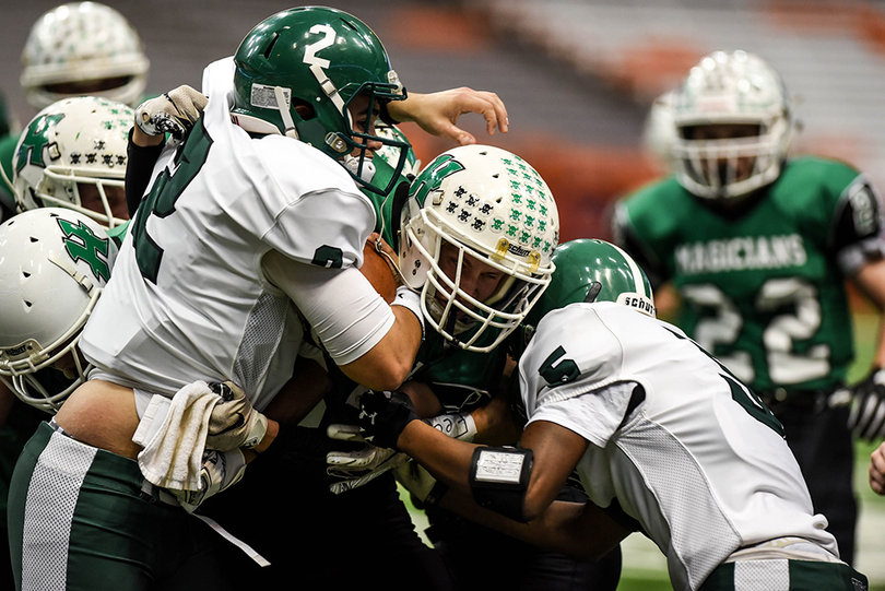 Herkimer linebacker Codey LaQuee is sandwiched between Onondaga's Zachary Delaney (No.2), and Andre Wright (No.5). 