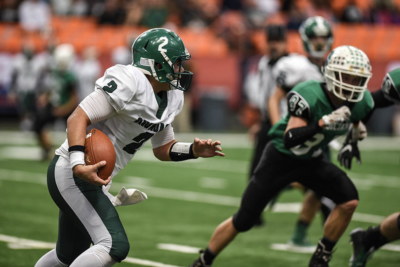 Delaney rushes downfield as Herkimer's Codey LaQuee closes in.  Onondaga defeated Herkimer 20-12 in Friday's game at the Carrier Dome.