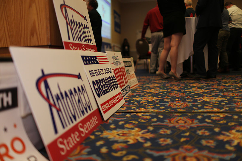 Campaign signs line the floors at the Republican watch party in the Sheraton Syracuse University Hotel & Conference Center. 