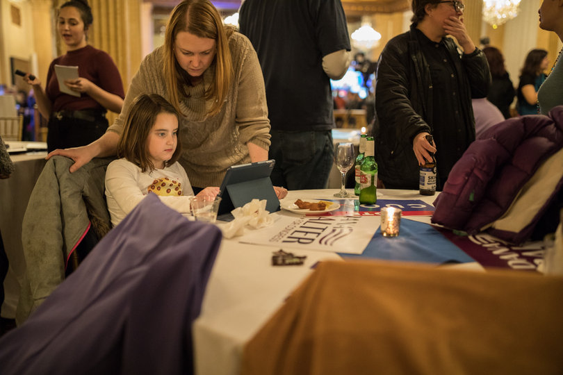 Ellyn Riley watches over her six-year-old daughter as Democratic supporters monitored the results of nationwide elections.