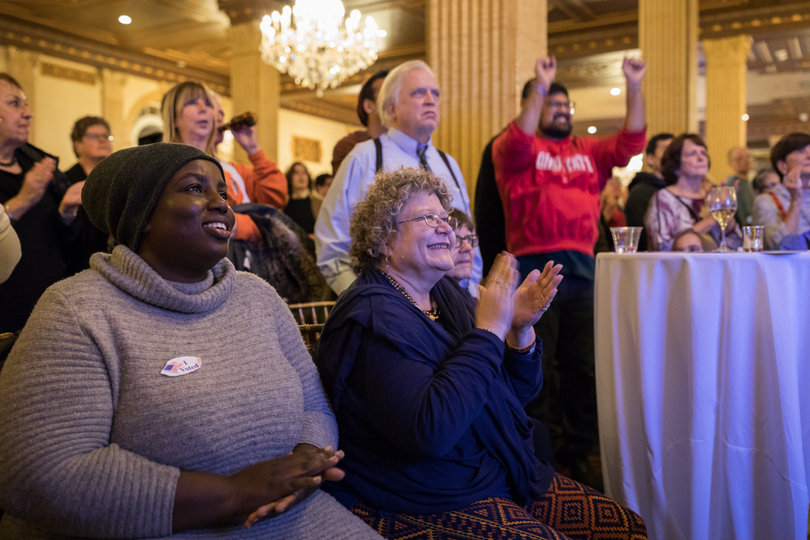 Palmer Harvey and Jaime Howley celebrate as more Democratic congressional winners are announced on CNN.