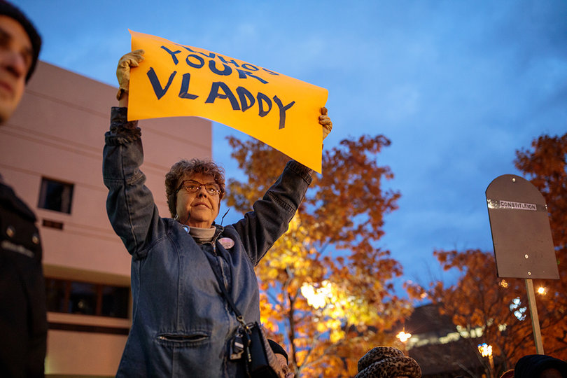 Janet Woodsworth, 62, holds a sign that reads "Who's Your Vladdy" at the "Nobody is Above the Law" Trump protest on Thursday, referring to Russian President Vladimir Putin.