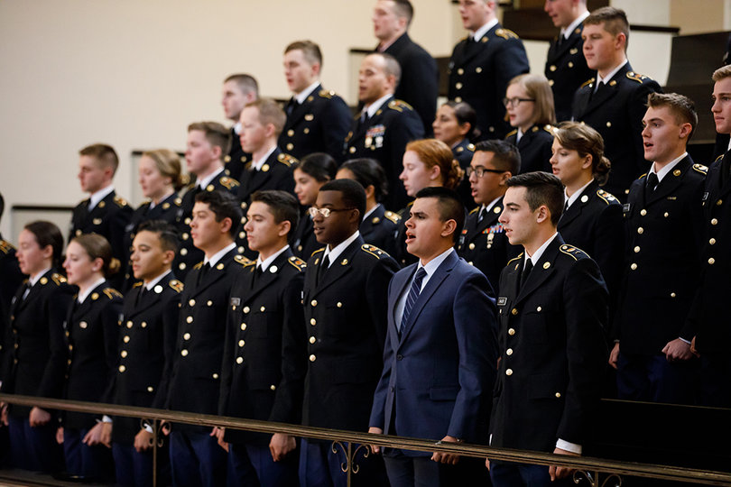Cadets in the university's Army ROTC program sing along to "The Army Goes Rolling Along," the official song of the U.S. Army. Members of the 198th Army Band played the anthems of each branch in the military.