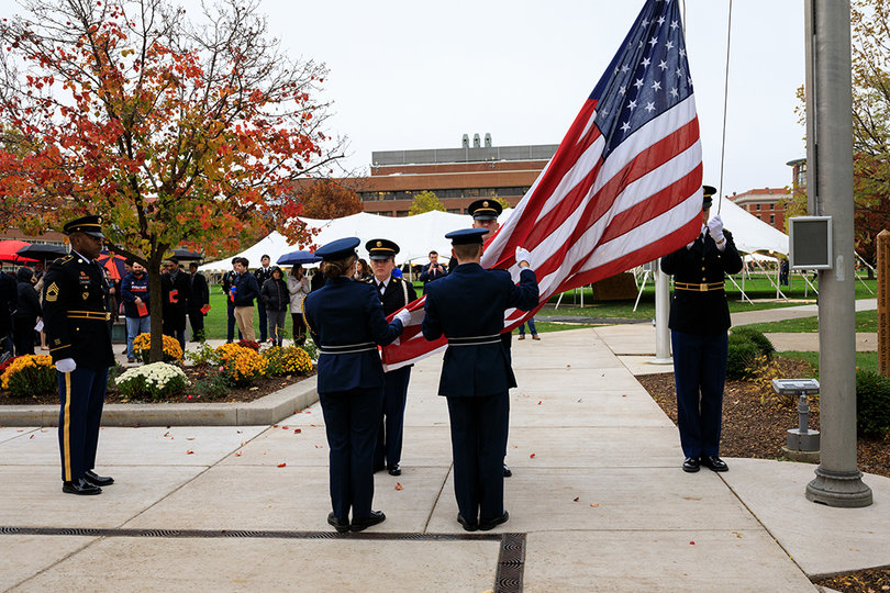 ROTC cadets raise the flag given to Chancellor Kent Syverud outside of Hendricks Chapel.