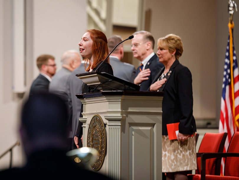 Katerina Skafidas, a senior vocal performance major, sings the National Anthem at the opening of the Veteran's Day ceremony at Hendricks Chapel.