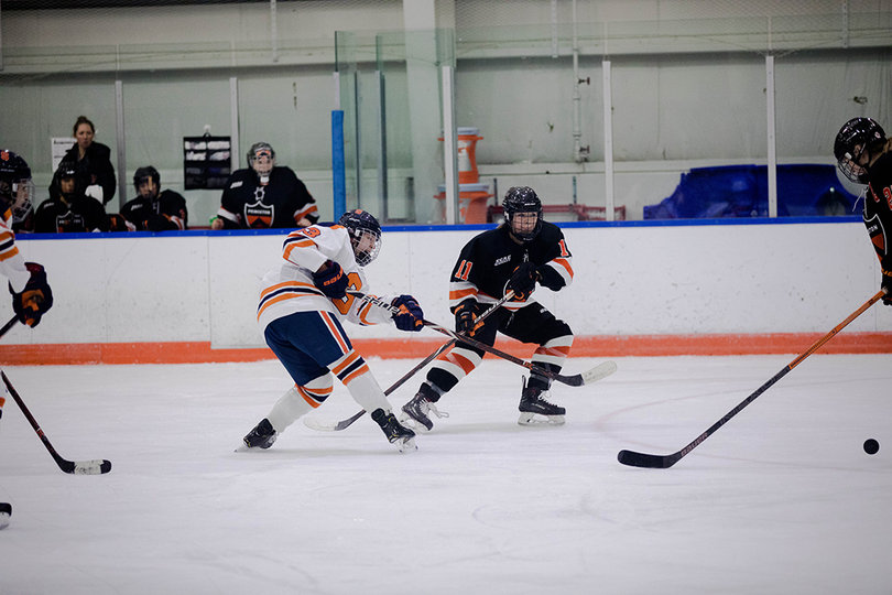 Abby Moloughney (#13) fights a Princeton player for the puck. 