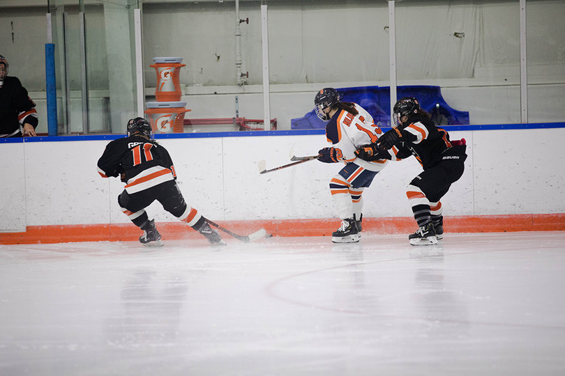 Abby Moluoughney (#13) made a good effort for the puck but was double-teamed. 