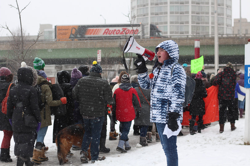 Max Mimaroglu chants as protesters march by. 