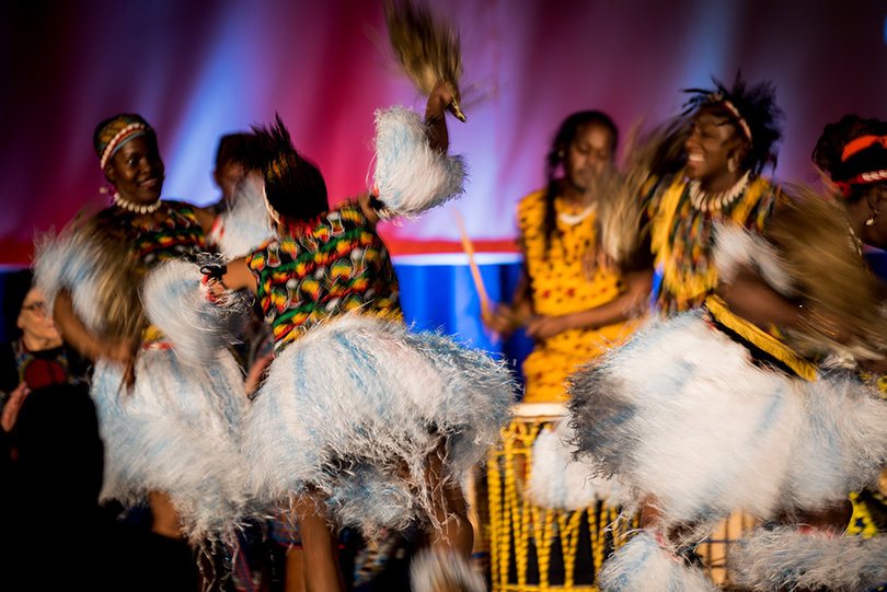 Four dancers with the Syracuse-based Adanfo Ensemble perform alongside the group's drummers.