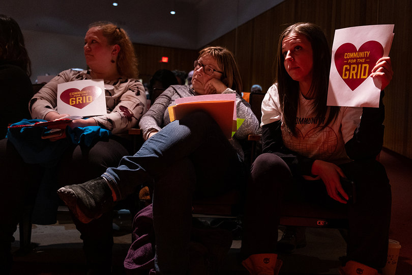 Syracuse residents Tammy Honeywell, Eva Carafa and Misse Ross were a few of the many that showed their support for the grid option.