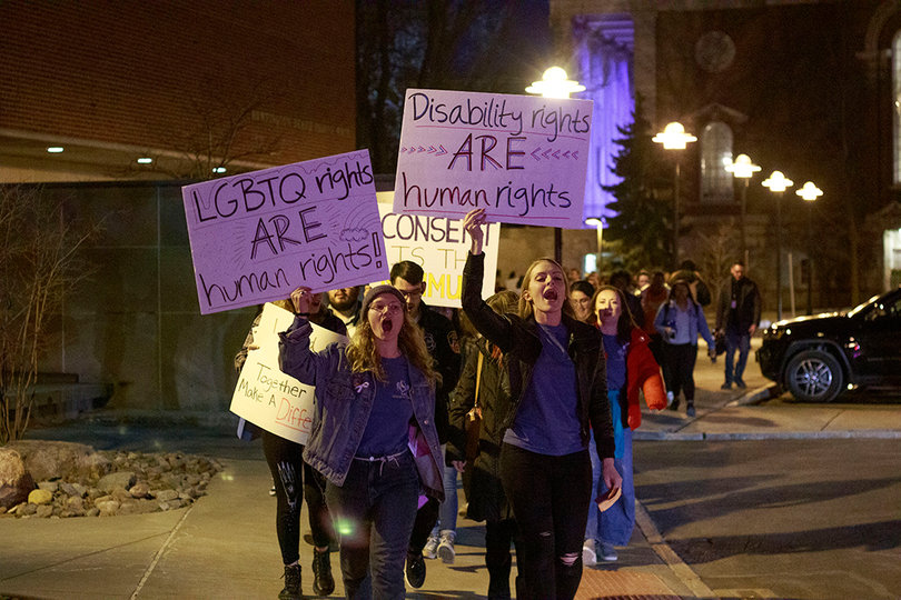 Jane Satter (junior) and Amy Buhrmaster (senior) lead the crowd of protesters. 