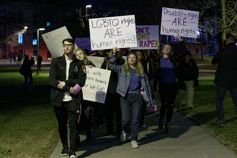 Jane Satter clutches a sign reading "LGBTQ rights are human rights" as she marches at Take Back the Night 2019. 