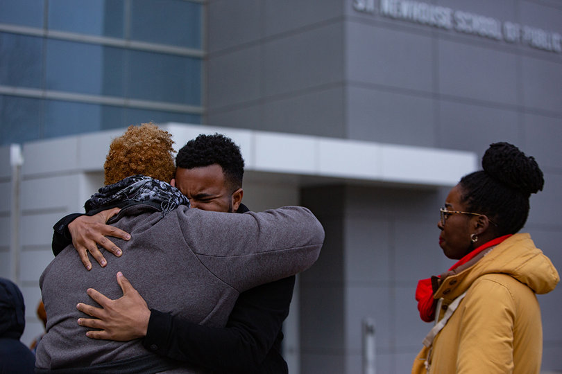 Russell Ladson embraces another person.