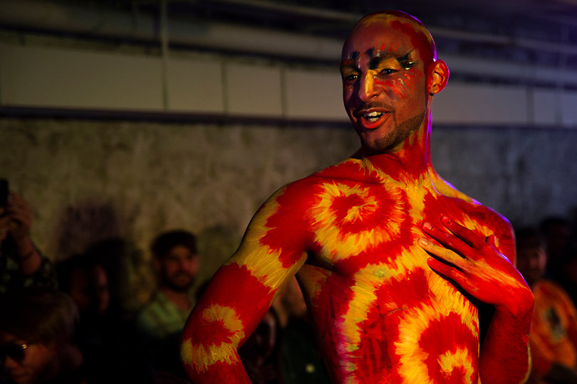 The crowd cheered for the model as he strutted down the runway.