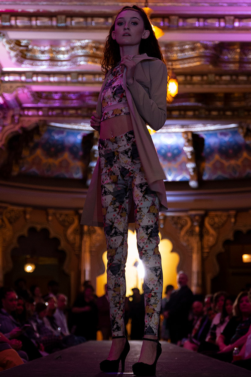A model waits to continue down the runway.