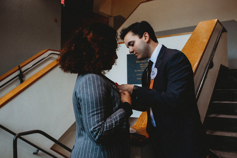 Daniel Preciado helps fellow scholar Ahlam Islam pin the Remembrance Scholar badge to her jacket.