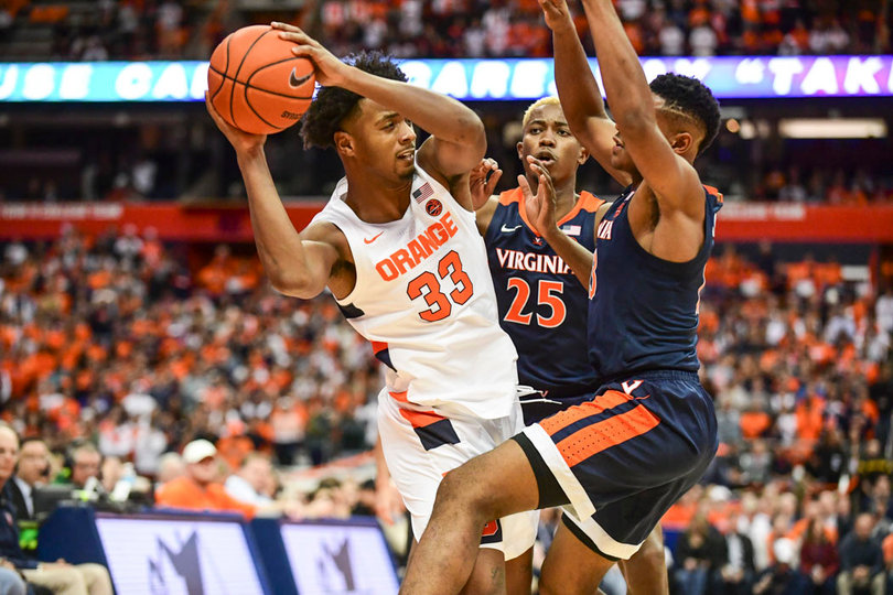 Elijah Hughes tries to pass out of a double-team