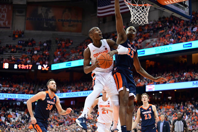 Jalen Carey tries to spin a layup off the glass and over a UVA rim protector