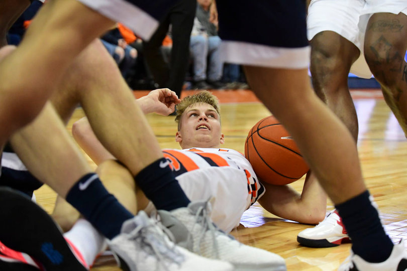 Marek Dolezaj lays on the court with the ball.