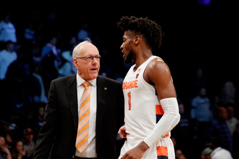 Head coach Jim Boeheim talks with freshman Quincy Guerrier as he heads to the bench.