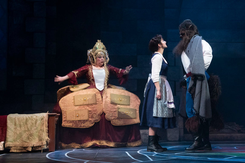 Stephanie Craven (center) who plays Belle, denies the Beast's dinner invitation.
