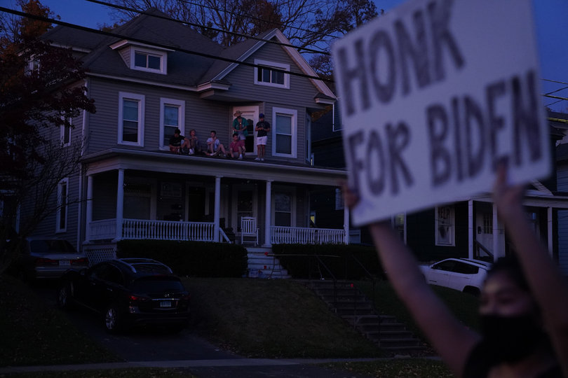 Nov. 8: Outside of her house on Euclid Avenue, Rachel Hayashi holds a sign that reads "Honk for Biden." Students on Hayashi's block played music from their porches to celebrate President-elect Joe Biden and Vice President-elect Kamala Harris' victory.