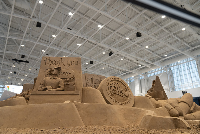 The sand sculpture features different scenes depicting first responders fighting against COVID-19. 
